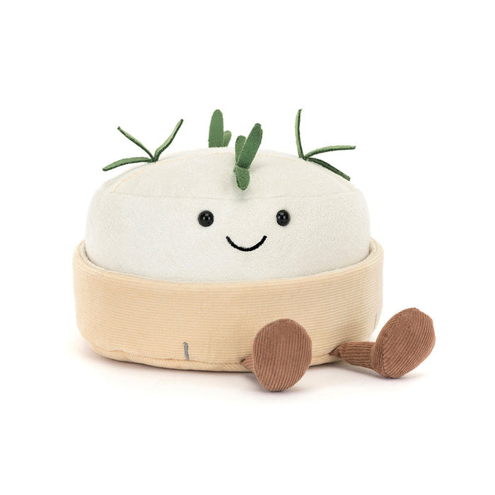 Plush toy resembling a block of camembert cheese with a smiling face on a white background