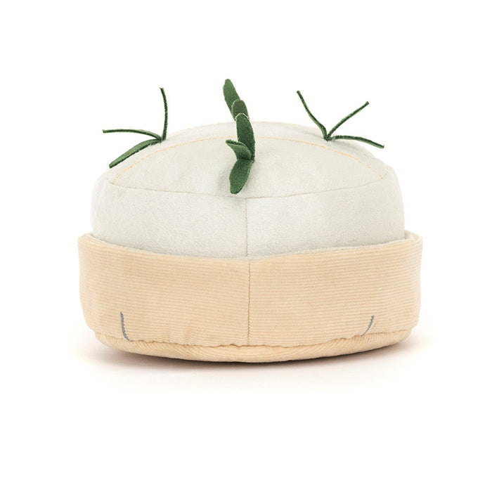 White plush toy shaped like a block of camembert cheese with green herbs on a white background
