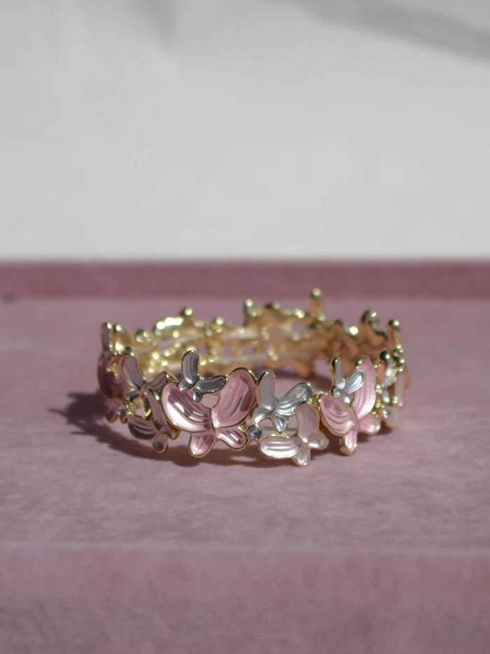 Bracelet with floral design on a pink surface