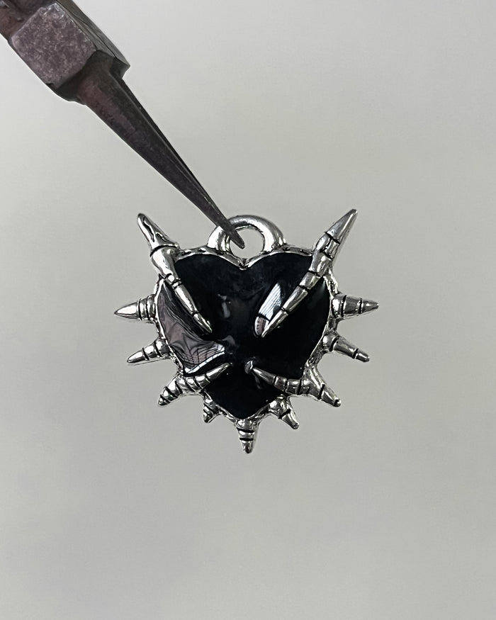 Black claw heart charm