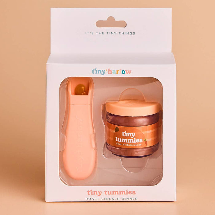 Package of 'tiny tummies' baby food jar and spoon with 'tiny harlow' branding on a beige background.