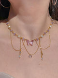 Fairy Vidia Choker Necklace necklace with multicolored beads and butterfly-shaped pendants, worn by a person.