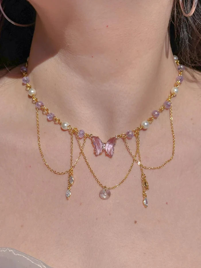 Fairy Vidia Choker Necklace necklace with multicolored beads and butterfly-shaped pendants, worn by a person.
