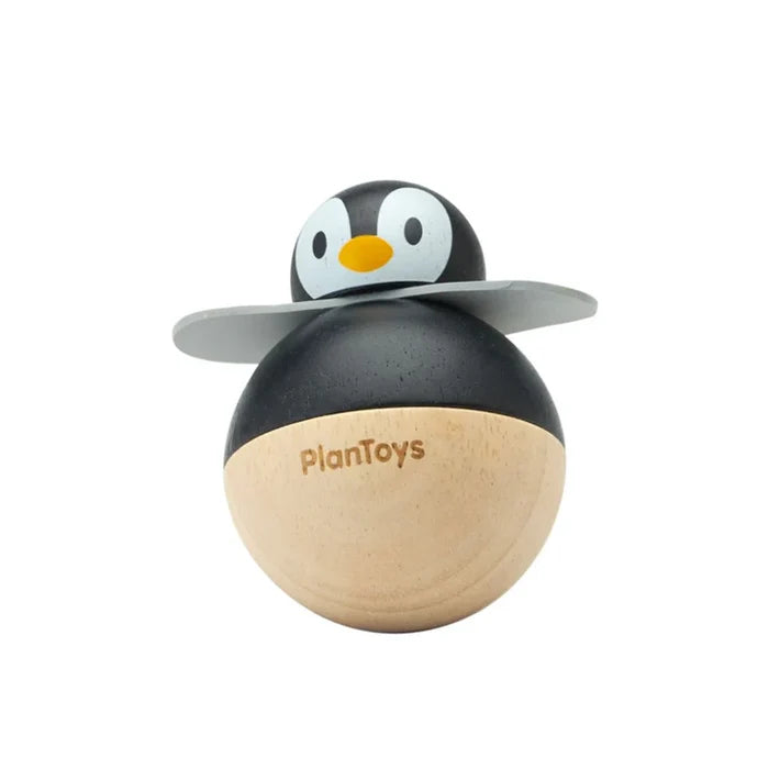 Wooden penguin toy with PlanToys branding on a white background
