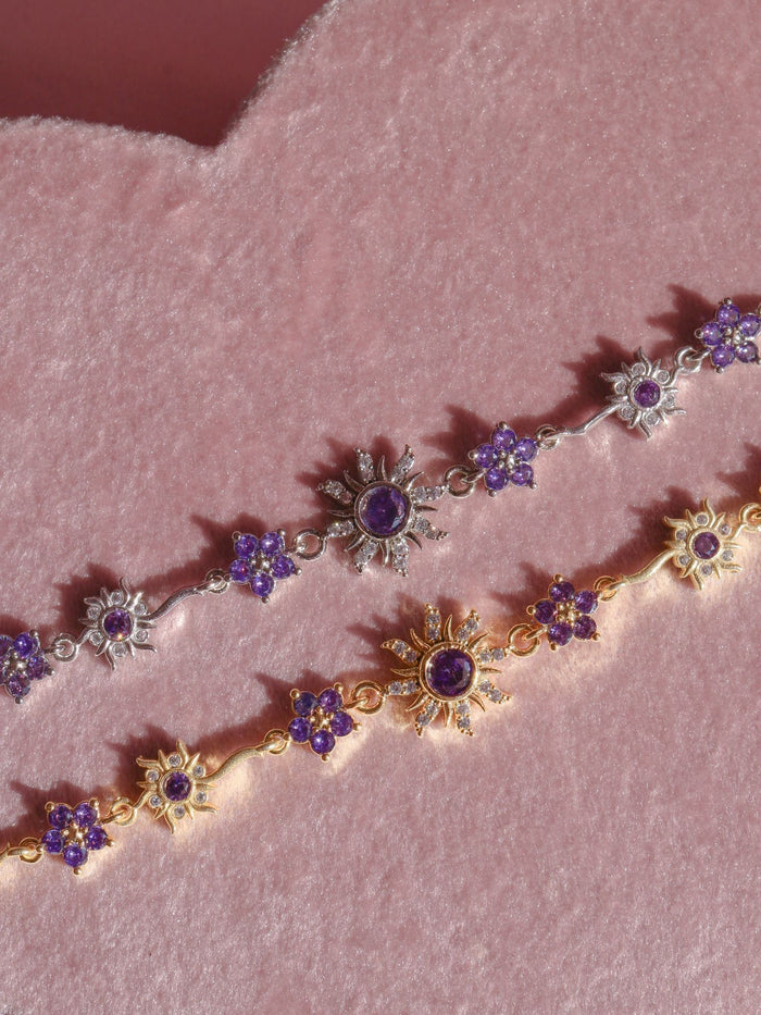 Rapunzel Gleam and Glow Sun Flower Bracelet with sun and purple floral flowers details.