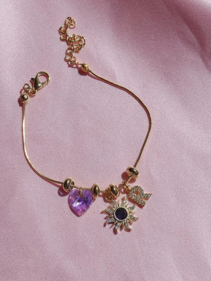 Rapunzel Sun Letter Charm Bracelet  with heart and sunflower charms.