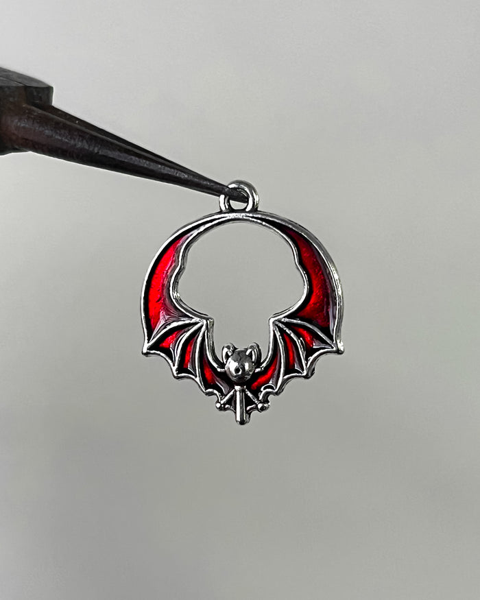 Red bat wing charm