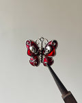 Red skull butterfly charm