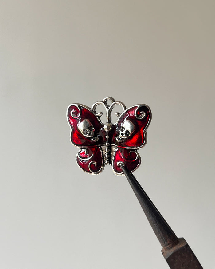 Red skull butterfly charm