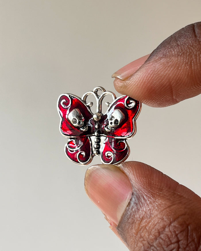 Red skull butterfly charm