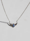 Swan Princess Necklace with a blue pendant on a light gray background