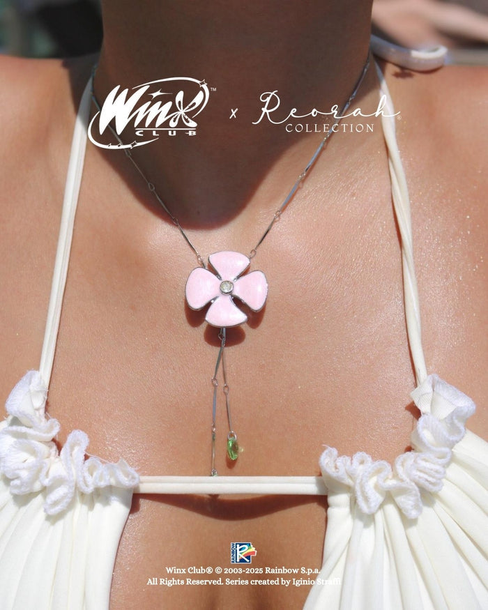 Bloom with Flora's natural magic wearing the Winx Club® Flora Flower Lariat Necklace. Officially licensed jewelry inspired by the Fairy of Nature, featuring an elegant floral lariat design.